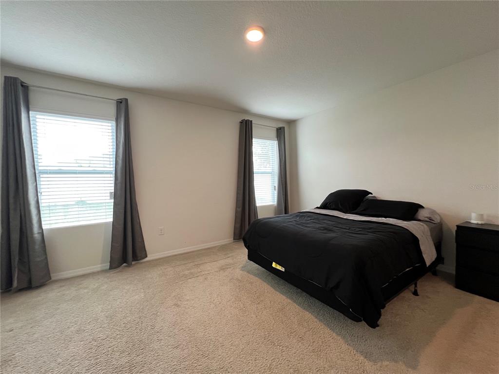 1756 Brockridge Road Kissimmee, FL 34744 - Photo 16 of 26 a bedroom with a bed and window