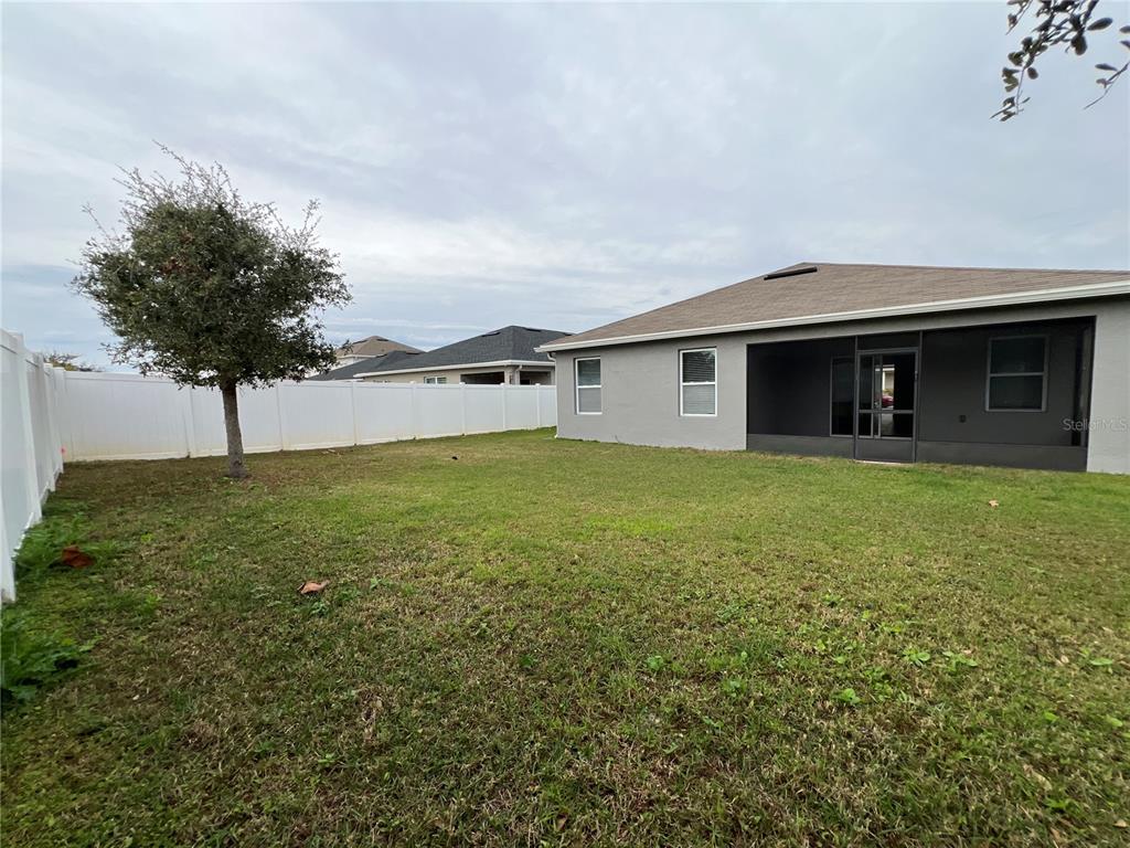 1756 Brockridge Road Kissimmee, FL 34744 - Photo 25 of 26 a view of a house with a yard and potted plants