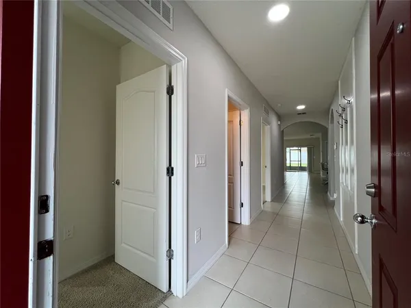 a view of a hallway with wooden shelves