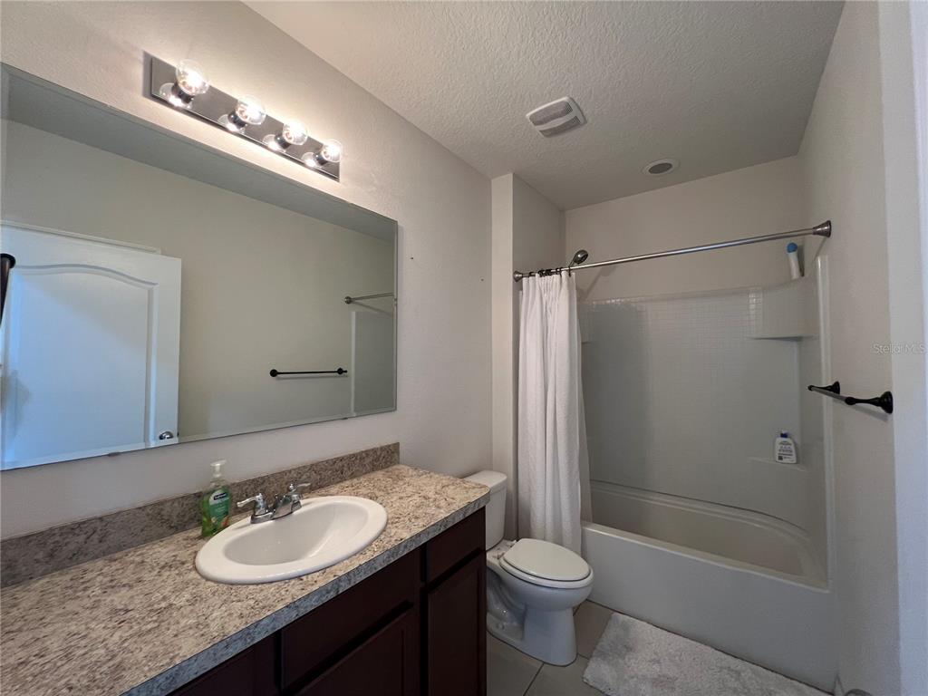 1756 Brockridge Road Kissimmee, FL 34744 - Photo 7 of 26 a bathroom with a sink a toilet and shower