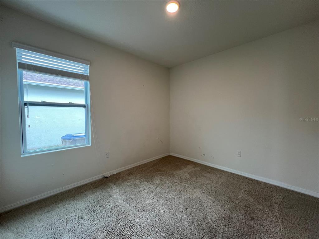 1756 Brockridge Road Kissimmee, FL 34744 - Photo 8 of 26 an empty room with a window