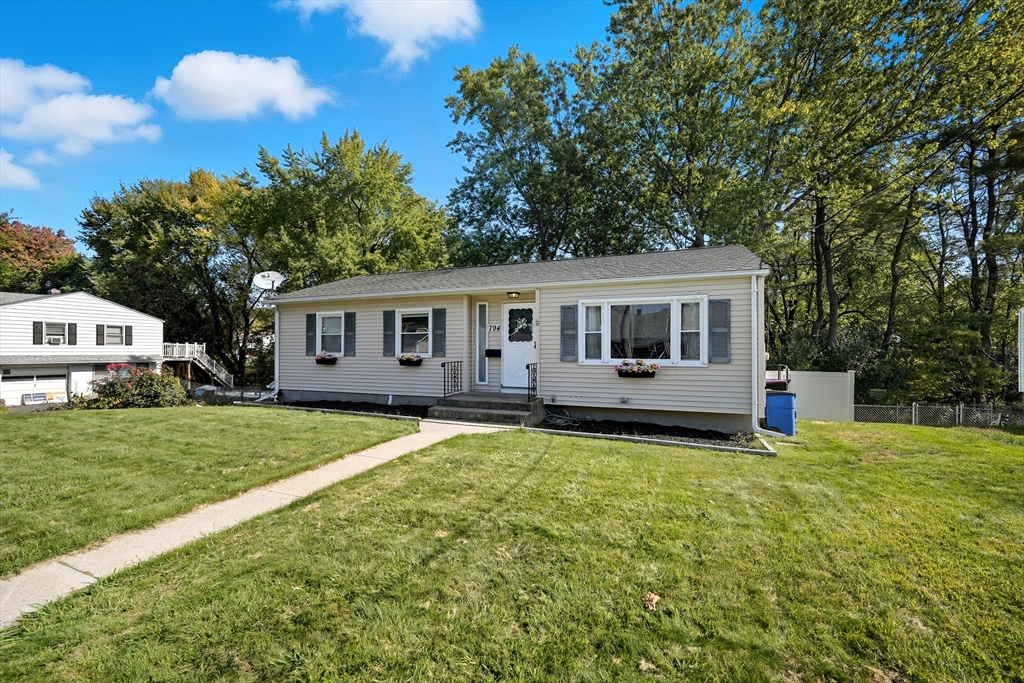 a front view of a house with yard porch and green space