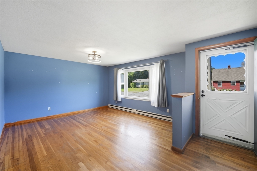 794 Homestead Avenue Holyoke, MA 01040 - Photo 15 of 34 a view of an empty room with window and wooden floor