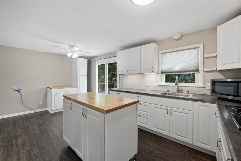 794 Homestead Avenue Holyoke, MA 01040 - Photo 10 of 34 a kitchen with sink cabinets and wooden floor