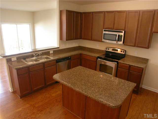 4607 Pat Reed Road Raleigh, NC 27616 - Photo 6 of 20 Eat-in kitchen at the island and at the bar! Tons of storage...