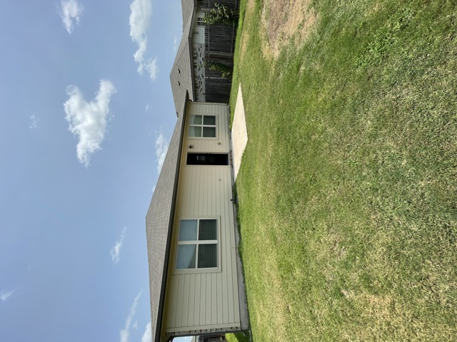 12401 Amber Lynn Path Manor, TX 78653 - Photo 31 of 33 A well-maintained side yard offers ample green space and a discreet side entrance.