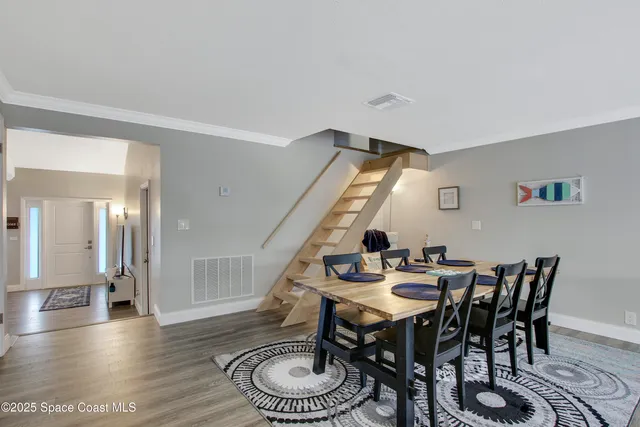 a kitchen with a stove a refrigerator and chairs