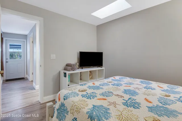 a bedroom with furniture and a wooden floor