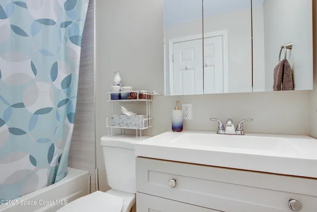 a bedroom with a bed and a view of bedroom