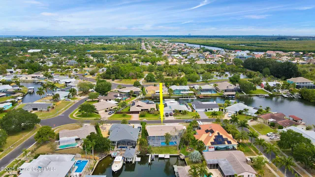 a living room with furniture and a painting on the wall