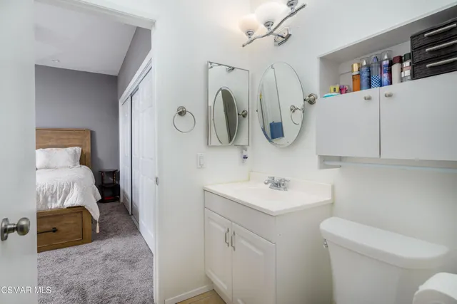 a bathroom with a sink vanity and toilet