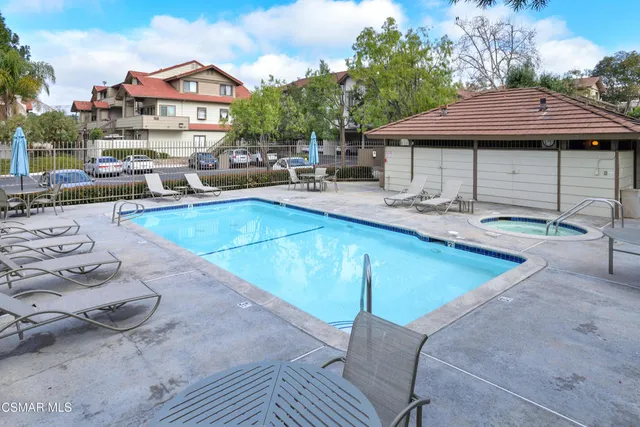 a view of a house with swimming pool and sitting area