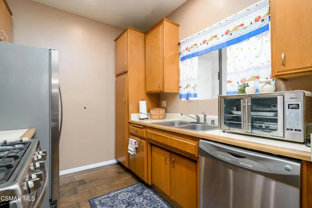 a kitchen with stainless steel appliances a sink and a window
