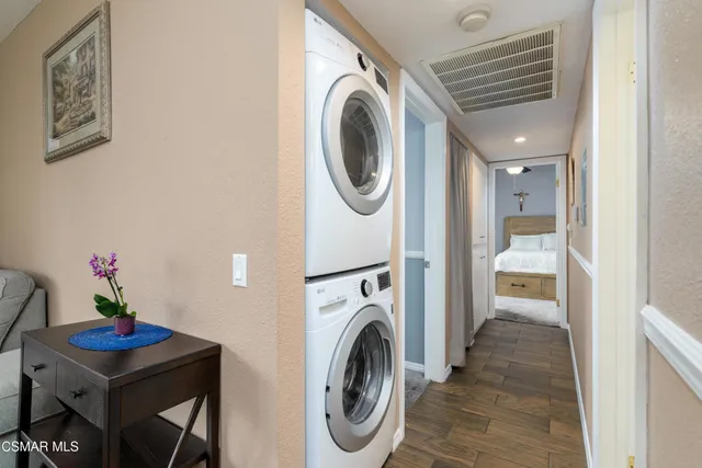 a view of a storage and utility room with washer and dryer