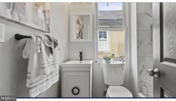a bathroom with a toilet sink and shower