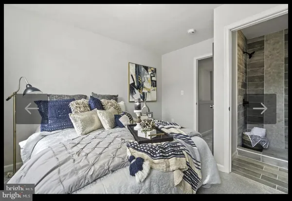 a bedroom with a bed and the view of bathroom