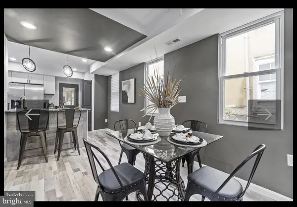 a view of a dining room with furniture and a large window