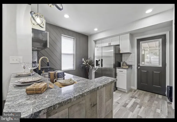 a kitchen with sink and refrigerator