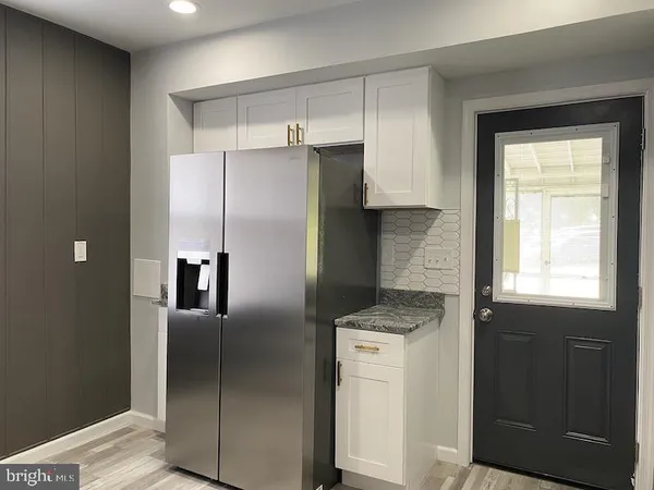 a kitchen with a refrigerator and a sink