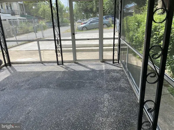 a view of an empty room with large windows