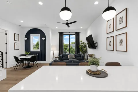 a living room with furniture chandelier and a large window