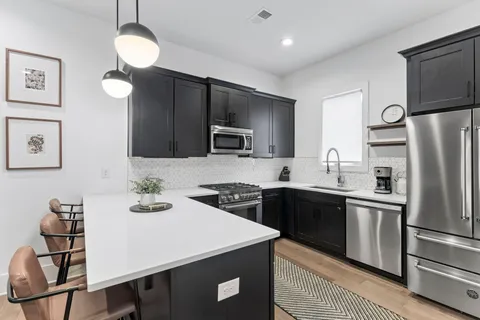 a kitchen with a center island and stainless steel appliances