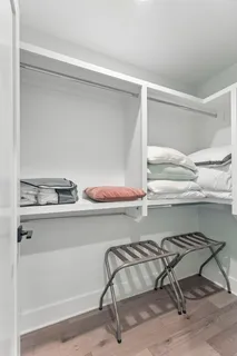 a utility room with lots of wooden cabinets and chair