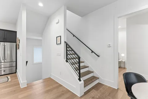 a view of entryway and hall with wooden floor