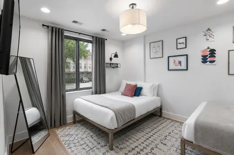 a bedroom with a bed and a window
