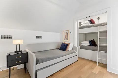 a bedroom with a bed and a lamp