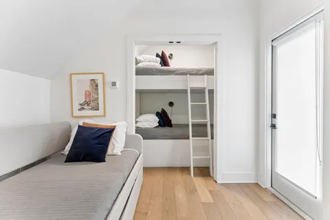 a bed room with a bed and a painting on the wall