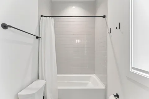 a bathroom with a bathtub and a shower