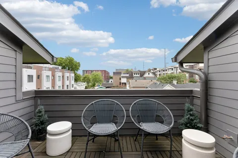 a balcony with table and chairs