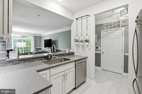 a kitchen with a sink and white cabinets