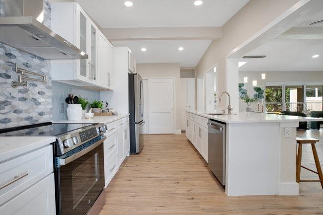 1926 Natalen Road Winter Park, FL 32792 - Photo 16 of 44 a large kitchen with stainless steel appliances kitchen island a large counter top and a stove