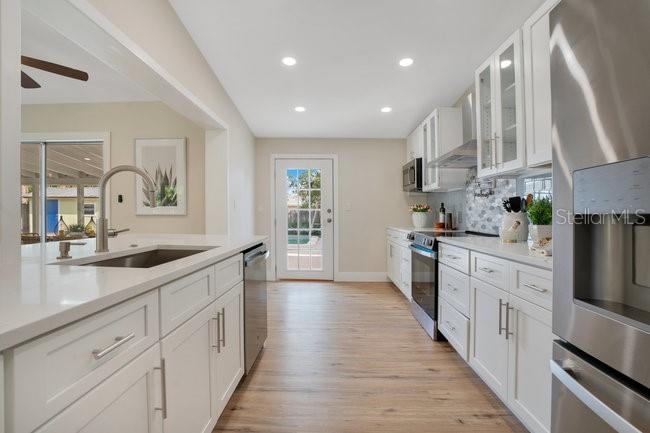 1926 Natalen Road Winter Park, FL 32792 - Photo 17 of 44 a large kitchen with stainless steel appliances sink a microwave and cabinets