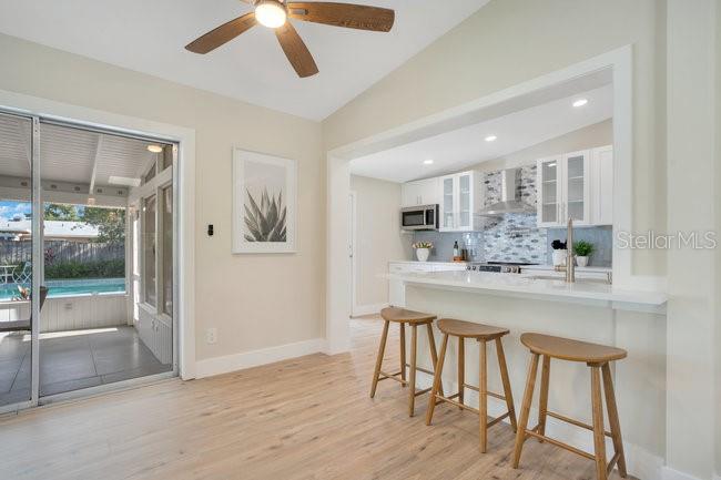 1926 Natalen Road Winter Park, FL 32792 - Photo 18 of 44 a kitchen with stainless steel appliances a table and chairs in it