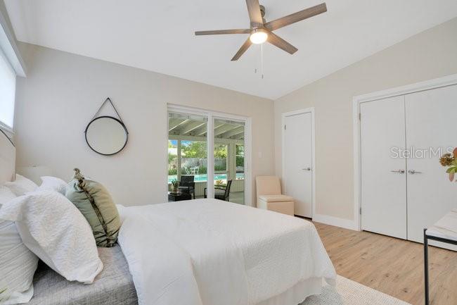 1926 Natalen Road Winter Park, FL 32792 - Photo 24 of 44 a bedroom with a large bed and a chandelier