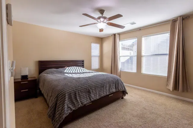 a spacious bedroom with a bed and a window