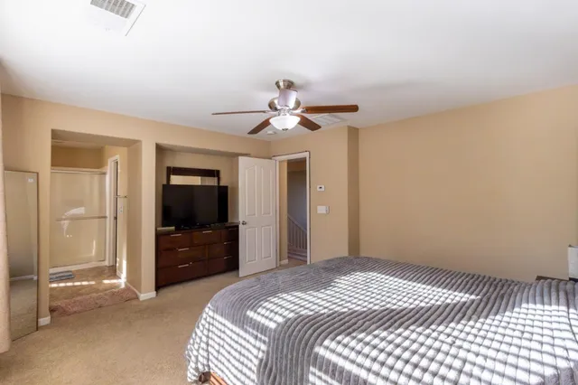 a spacious bathroom with a granite countertop sink and a mirror