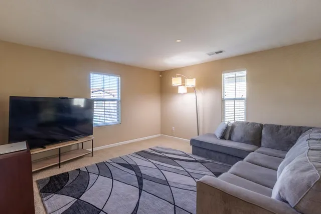 a view of a hallway with workspace and windows