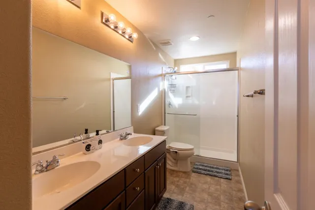 a bedroom with bed couch and window