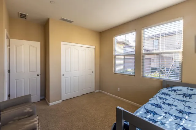 a bathroom with a double vanity sink toilet mirror and shower