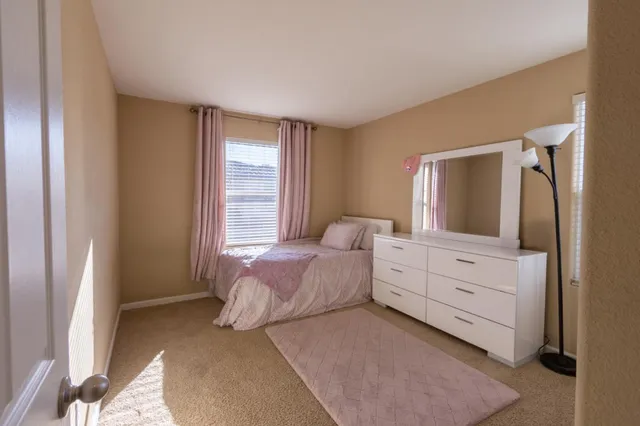 a bedroom with a bed and a dresser