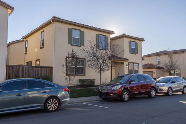 a view of a brick house with many windows