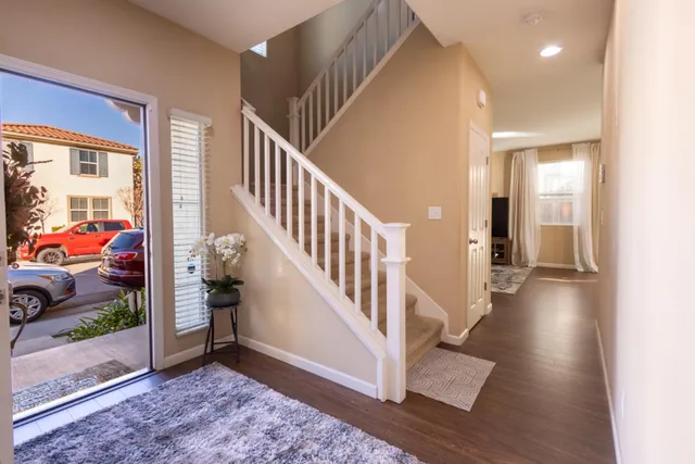 a living room with furniture a dining table and a potted plant