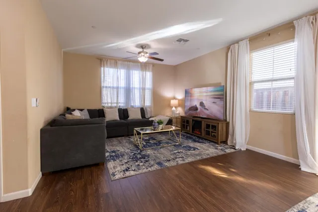a kitchen with kitchen island granite countertop wooden cabinets and a refrigerator
