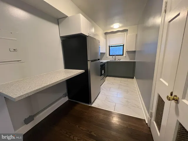 a kitchen with stainless steel appliances a refrigerator and a stove