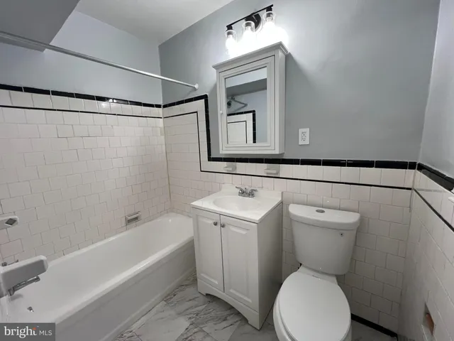 a bathroom with a toilet a sink and bathtub