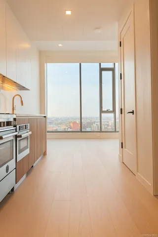 a view of a kitchen with a sink and a large window